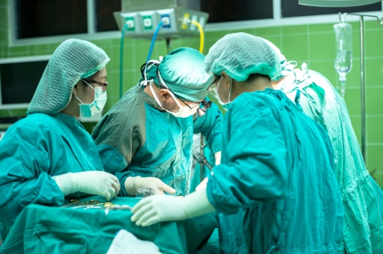 Doctors and nurses in operating theater ministering healing