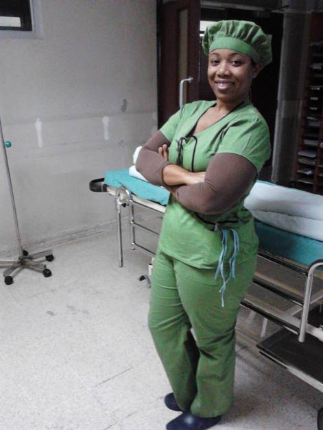 Nurse in green scrubs standing in operating theater